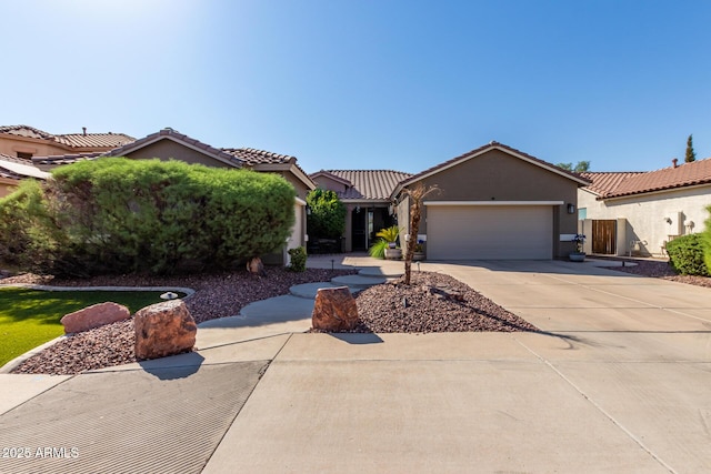13629 W San Miguel Ave, Litchfield Park, AZ 85340 - view of front facade with a garage, driveway, stucco siding, and a tiled roof