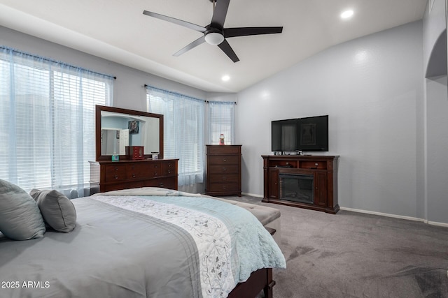 13629 W San Miguel Ave, Litchfield Park, AZ 85340 - bedroom featuring light carpet, baseboards, a glass covered fireplace, vaulted ceiling, and ceiling fan