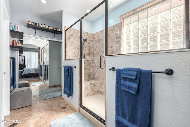 13629 W San Miguel Ave, Litchfield Park, AZ 85340 - bathroom with connected bathroom, a shower stall, and baseboards
