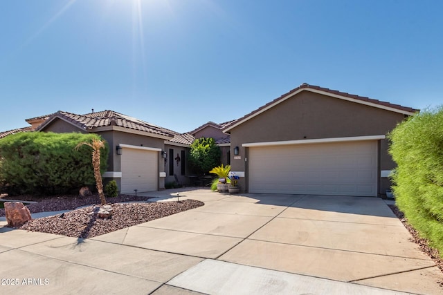 13629 W San Miguel Ave, Litchfield Park, AZ 85340 - view of front of house with an attached garage, stucco siding, a tile roof, and concrete driveway