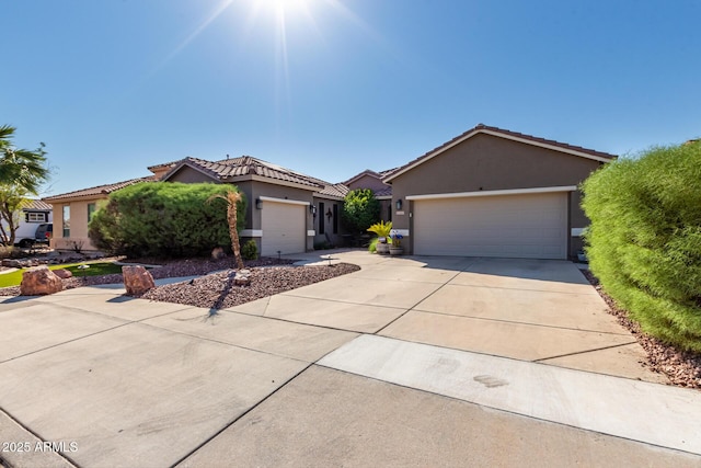 13629 W San Miguel Ave, Litchfield Park, AZ 85340 - view of front facade with concrete driveway, an attached garage, stucco siding, and a tile roof