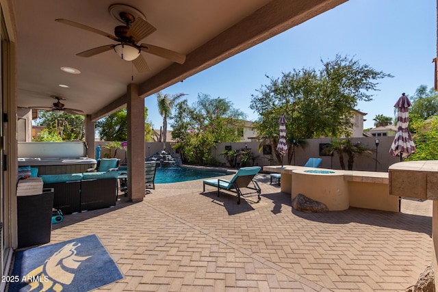 13629 W San Miguel Ave, Litchfield Park, AZ 85340 - fenced backyard with a covered hot tub, a ceiling fan, a patio, and a fire pit
