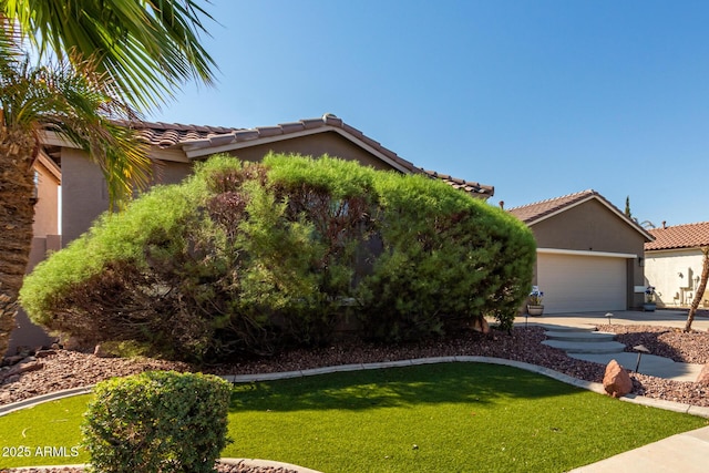 13629 W San Miguel Ave, Litchfield Park, AZ 85340 - view of front of property with a front lawn, a tiled roof, and stucco siding