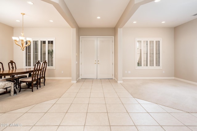 foyer entrance featuring light carpet, light tile patterned floors, baseboards, an inviting chandelier, and recessed lighting