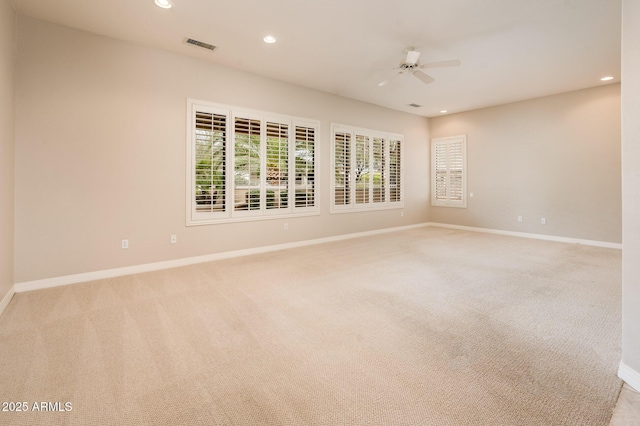 unfurnished room featuring recessed lighting, light carpet, and baseboards