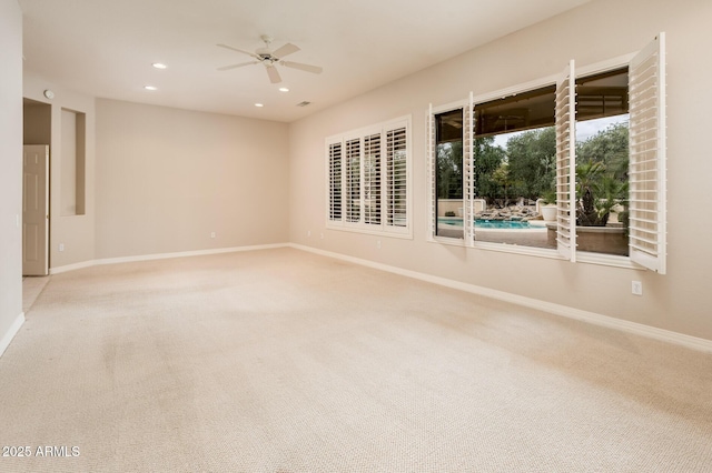 carpeted empty room featuring baseboards, a ceiling fan, and recessed lighting