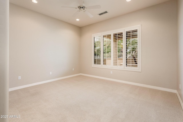 empty room with ceiling fan, light colored carpet, recessed lighting, visible vents, and baseboards