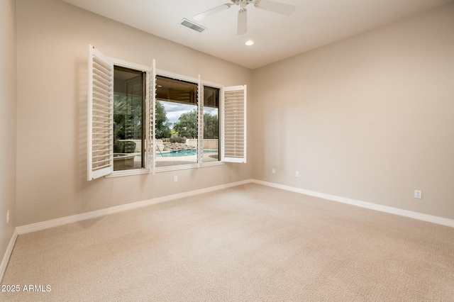 spare room featuring recessed lighting, carpet flooring, visible vents, and baseboards