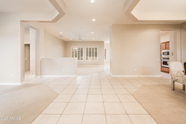 empty room featuring light tile patterned floors, baseboards, a ceiling fan, and recessed lighting