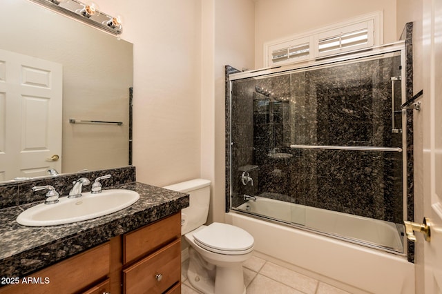 bathroom with shower / bath combination with glass door, vanity, toilet, and tile patterned floors