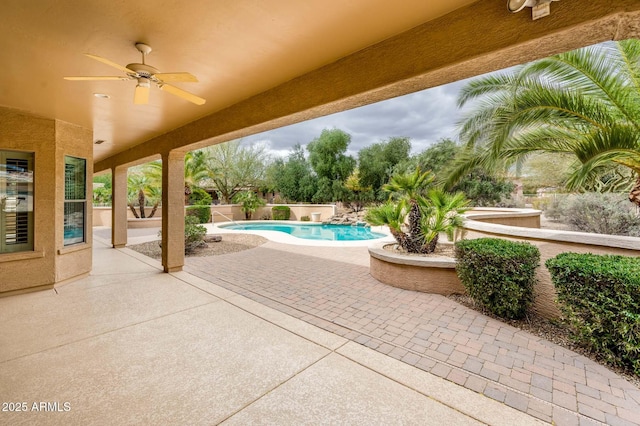 view of swimming pool with a fenced in pool, a patio area, and ceiling fan