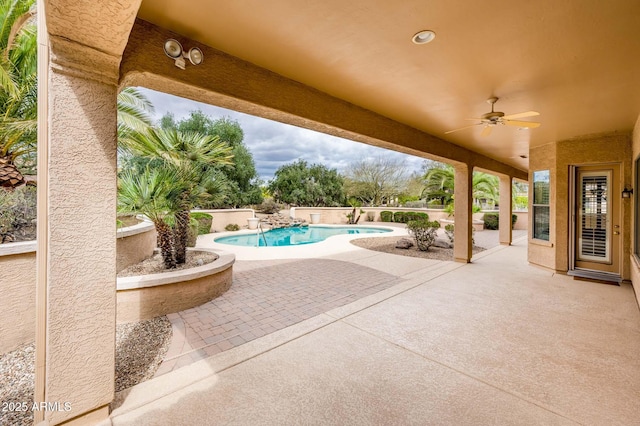 view of patio / terrace featuring a ceiling fan and a fenced in pool