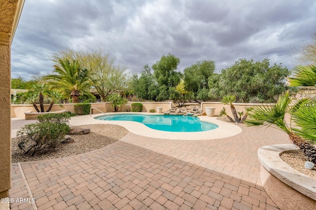 view of pool with a fenced in pool, a patio area, and a fenced backyard