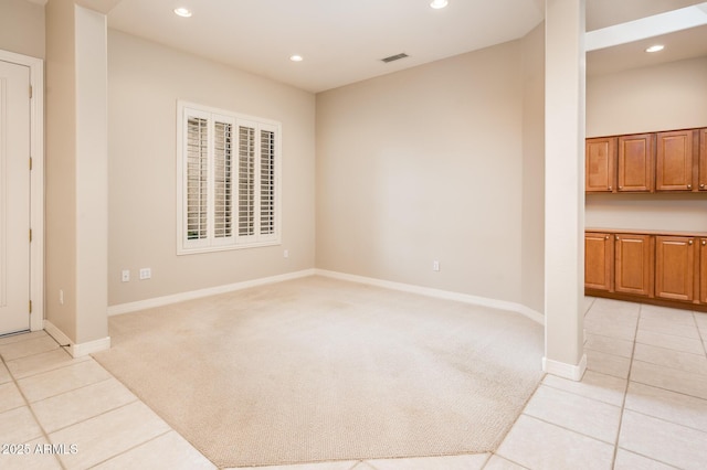 spare room with recessed lighting, light colored carpet, visible vents, and light tile patterned floors