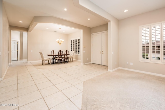 interior space with light tile patterned flooring, a chandelier, and recessed lighting