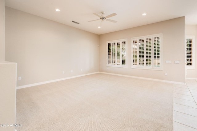 spare room featuring ceiling fan, recessed lighting, light carpet, visible vents, and baseboards