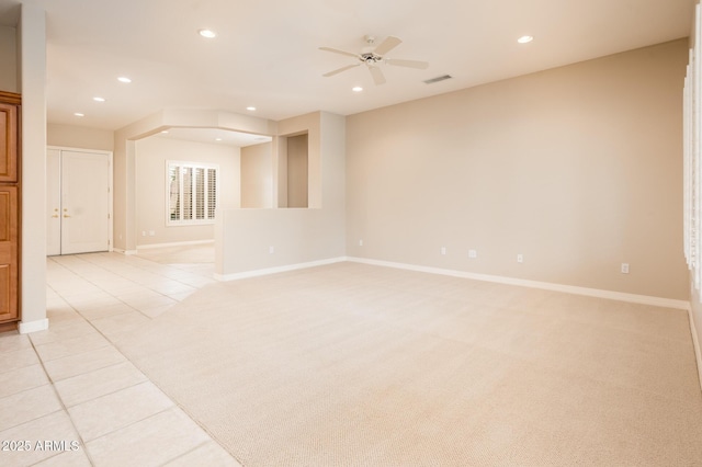 empty room featuring recessed lighting, light colored carpet, visible vents, and light tile patterned flooring