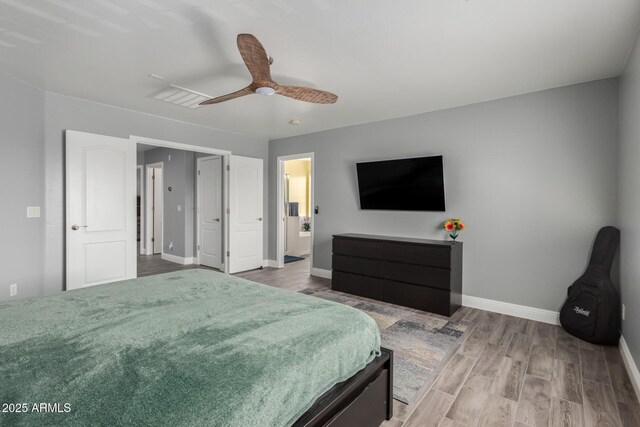 bedroom with baseboards, visible vents, wood finished floors, and ceiling fan