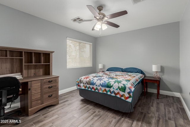 bedroom with baseboards, visible vents, wood finished floors, and a ceiling fan