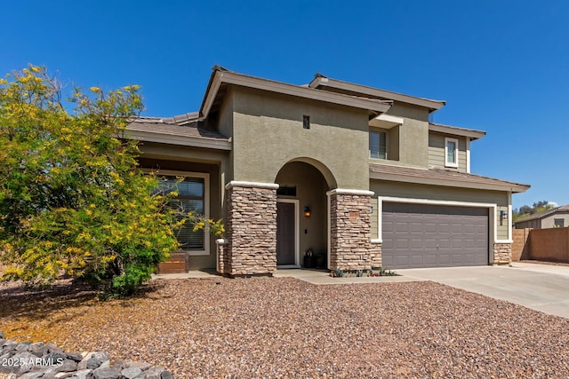 view of front facade with stone siding, an attached garage, stucco siding, and concrete driveway