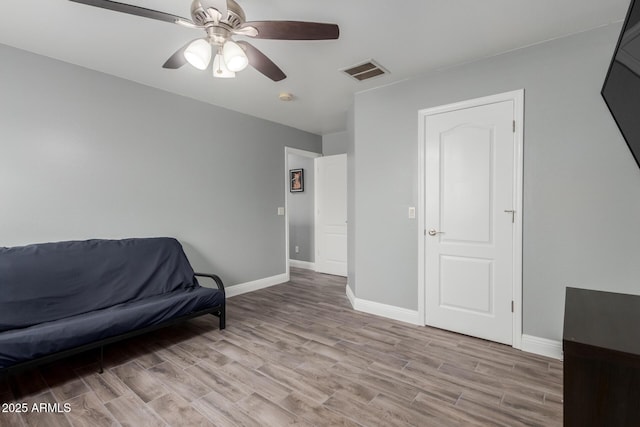 sitting room featuring baseboards, visible vents, wood finished floors, and a ceiling fan