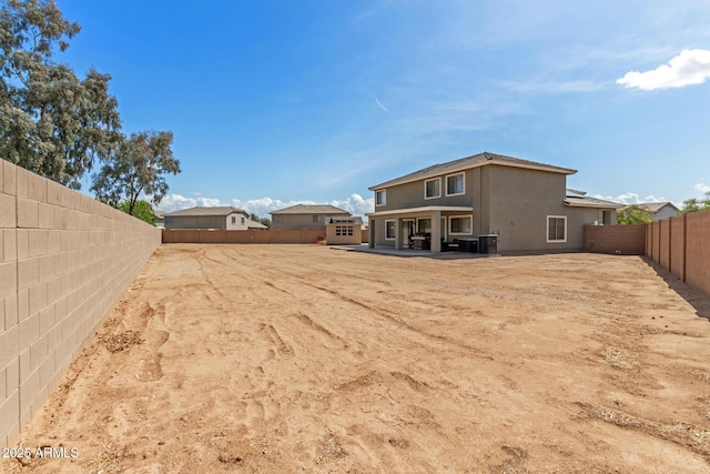 view of yard with a fenced backyard, central AC unit, and a patio