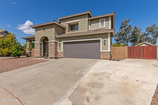 prairie-style home with driveway, a gate, stone siding, fence, and a garage