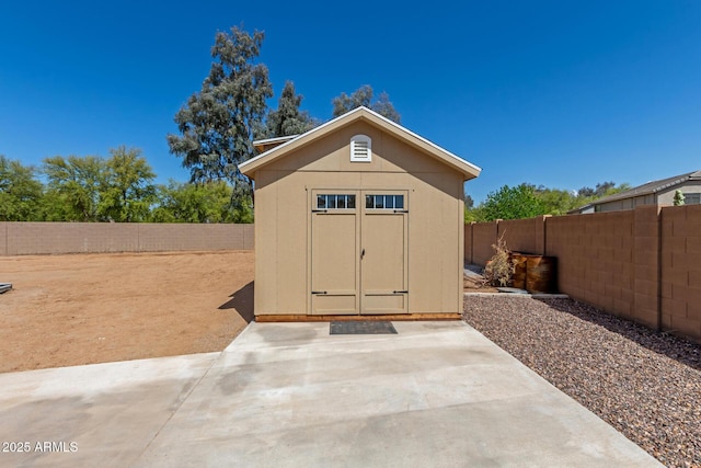 view of shed featuring a fenced backyard