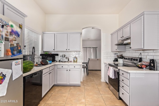 7310 N 68th Ln, Glendale, AZ 85303 - kitchen featuring stainless steel appliances, under cabinet range hood, tasteful backsplash, light countertops, and light tile patterned flooring