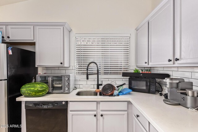 7310 N 68th Ln, Glendale, AZ 85303 - kitchen with dishwashing machine, black microwave, decorative backsplash, light countertops, and freestanding refrigerator