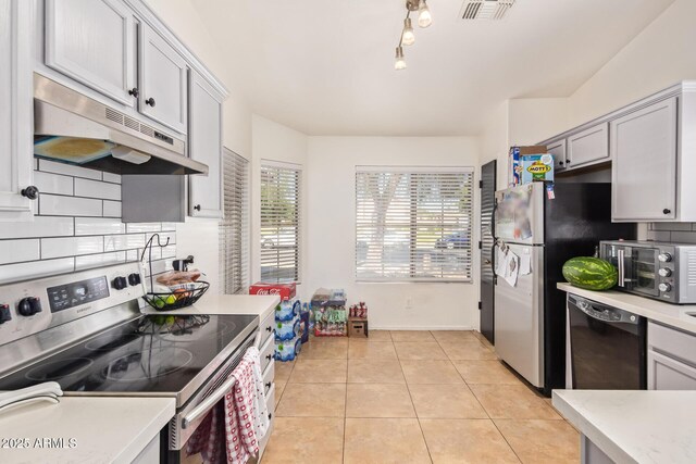 7310 N 68th Ln, Glendale, AZ 85303 - kitchen with stainless steel range with electric stovetop, under cabinet range hood, dishwasher, and light countertops