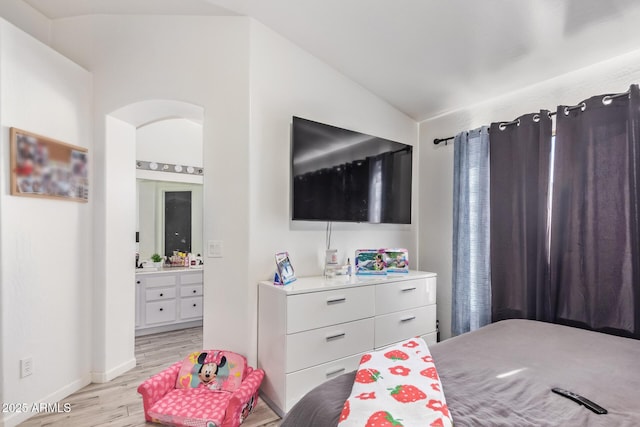 7310 N 68th Ln, Glendale, AZ 85303 - bedroom featuring vaulted ceiling, light wood-type flooring, and ensuite bathroom