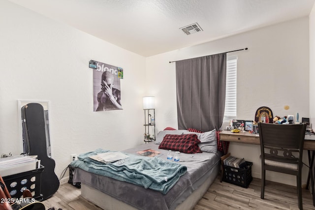 7310 N 68th Ln, Glendale, AZ 85303 - bedroom with wood finished floors and baseboards