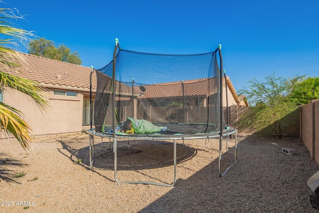 7310 N 68th Ln, Glendale, AZ 85303 - fenced backyard featuring a trampoline