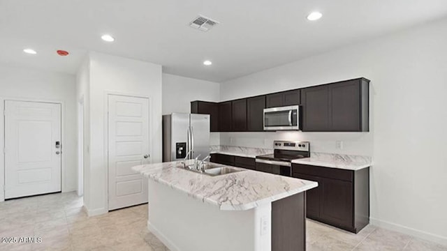 1337 W Hess Ave, Coolidge, AZ 85128 - kitchen with stainless steel appliances, a sink, a center island with sink, baseboards, and recessed lighting