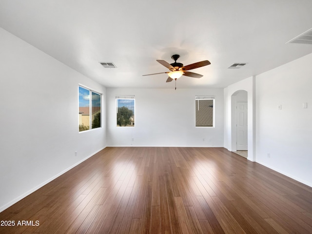 unfurnished room with dark wood-type flooring and ceiling fan