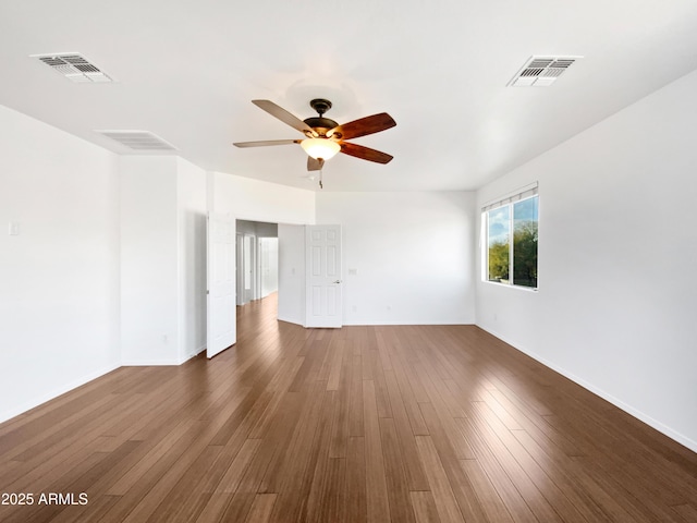 unfurnished room with dark hardwood / wood-style floors and ceiling fan