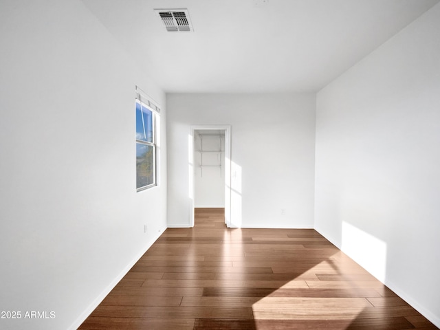 spare room with dark hardwood / wood-style flooring