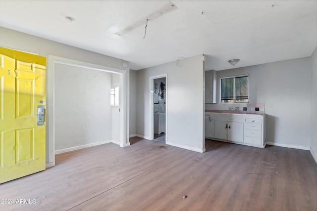 interior space featuring light hardwood / wood-style floors and white cabinetry