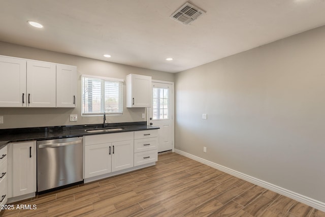 4001 E Apollo Rd, Phoenix, AZ 85042 - kitchen featuring dishwasher, light wood finished floors, white cabinetry, dark countertops, and recessed lighting