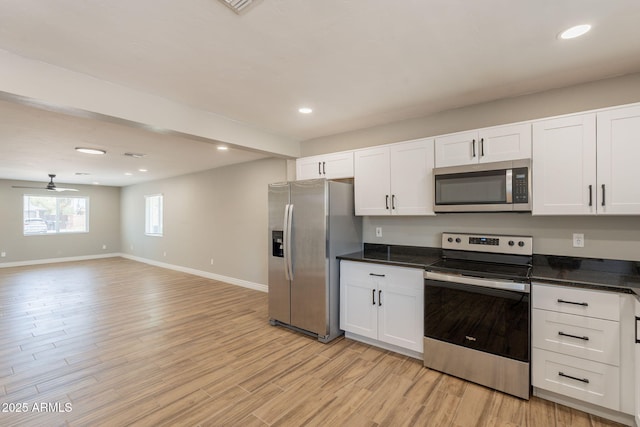 4001 E Apollo Rd, Phoenix, AZ 85042 - kitchen with stainless steel appliances, dark countertops, white cabinetry, light wood-style flooring, and recessed lighting