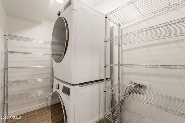 4001 E Apollo Rd, Phoenix, AZ 85042 - laundry area featuring stacked washer and clothes dryer and wood finished floors