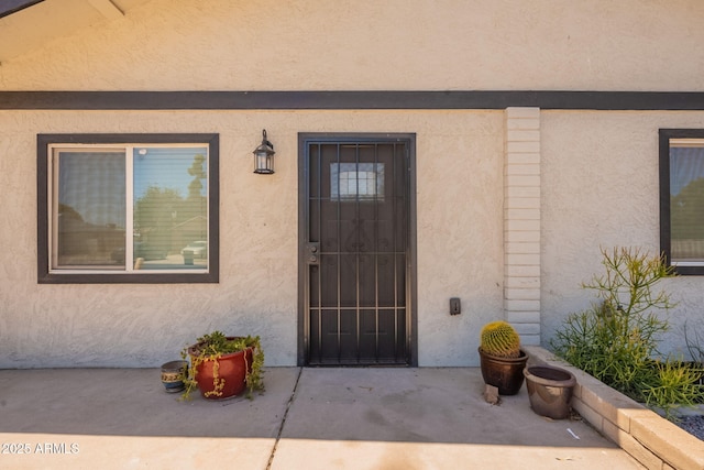 4001 E Apollo Rd, Phoenix, AZ 85042 - doorway to property with stucco siding and a patio area