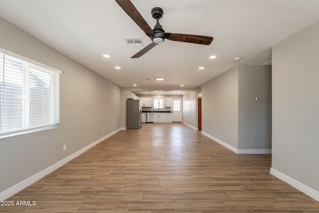 4001 E Apollo Rd, Phoenix, AZ 85042 - unfurnished living room with a ceiling fan, light wood-type flooring, and recessed lighting