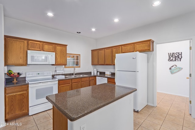 kitchen with a kitchen island, white appliances, sink, and light tile patterned floors