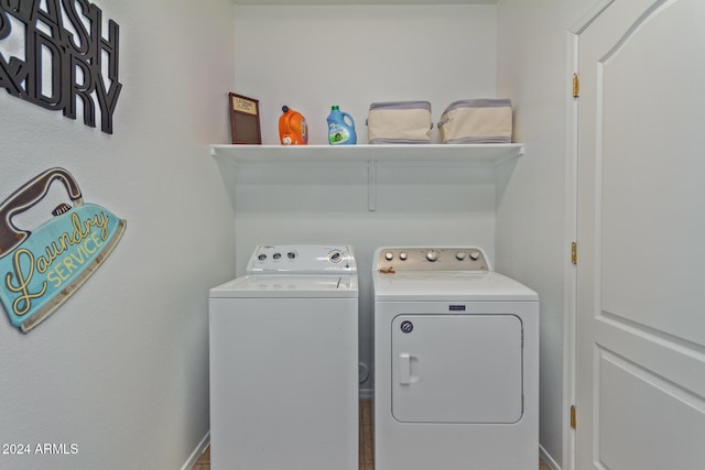 washroom featuring washer and clothes dryer