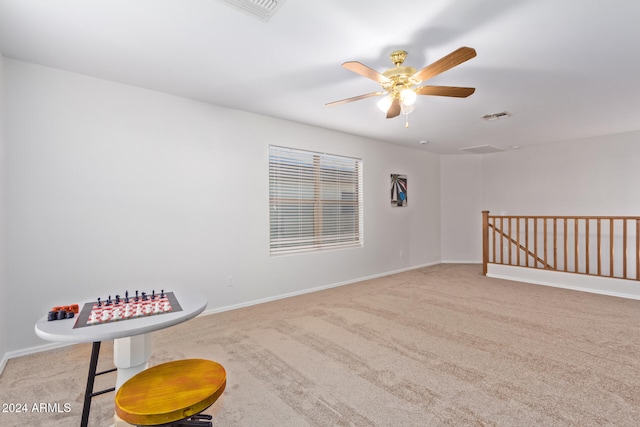 interior space with ceiling fan and light carpet
