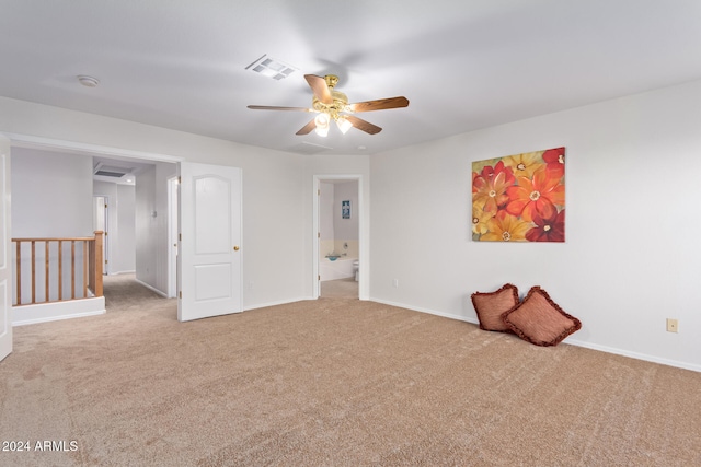 carpeted spare room featuring ceiling fan