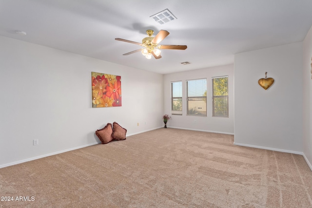 unfurnished room featuring light colored carpet and ceiling fan