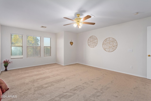 empty room featuring light carpet and ceiling fan
